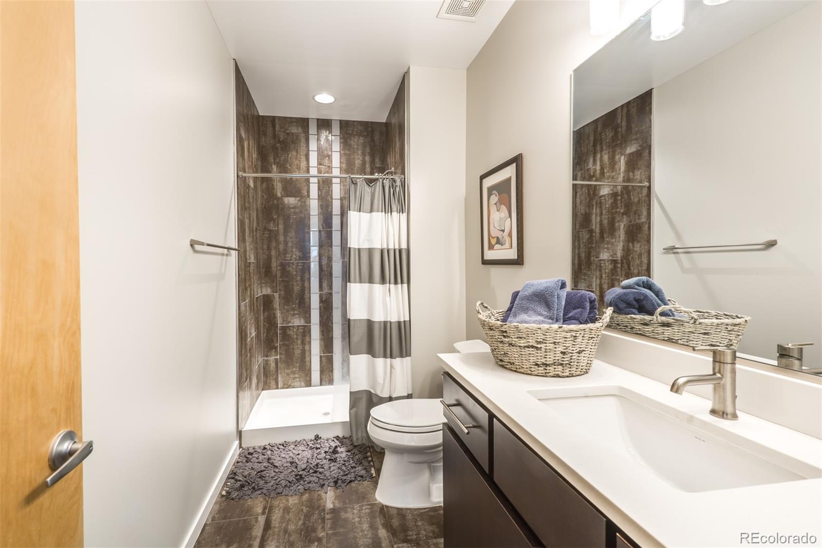 4030 Bryant Street Denver, CO 80211 - Photo 23 of 26 a bathroom with a double vanity sink toilet and shower