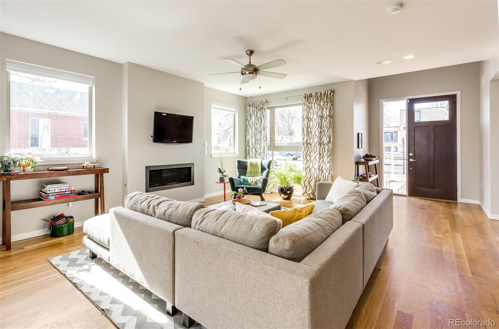 4030 Bryant Street Denver, CO 80211 - Photo 3 of 26 a living room with furniture fireplace and a flat screen tv