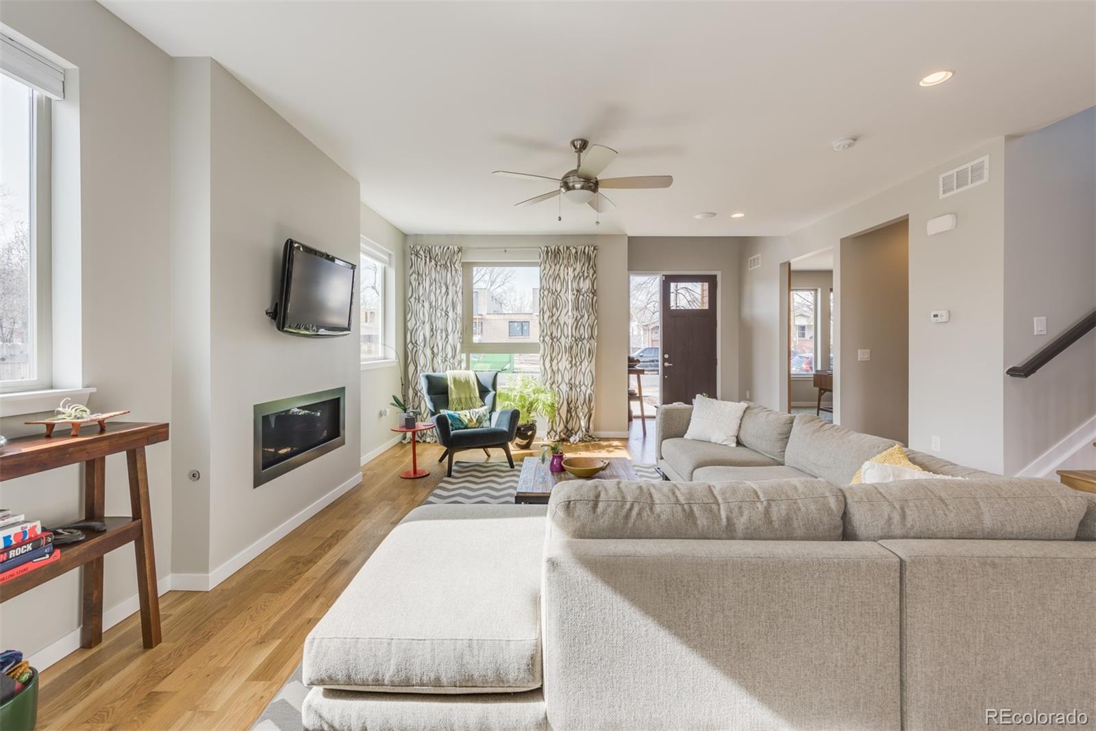 4030 Bryant Street Denver, CO 80211 - Photo 4 of 26 a living room with furniture a fireplace and a flat screen tv