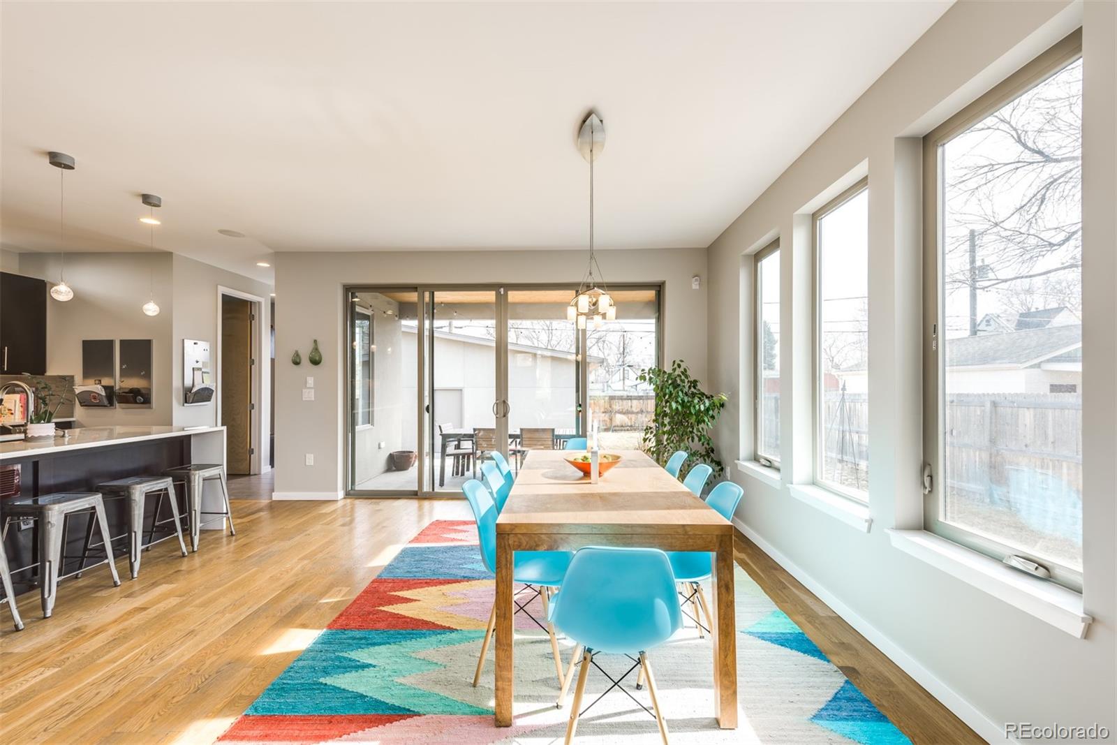 4030 Bryant Street Denver, CO 80211 - Photo 8 of 26 a dining room with wooden floor a chandelier a wooden table and chairs