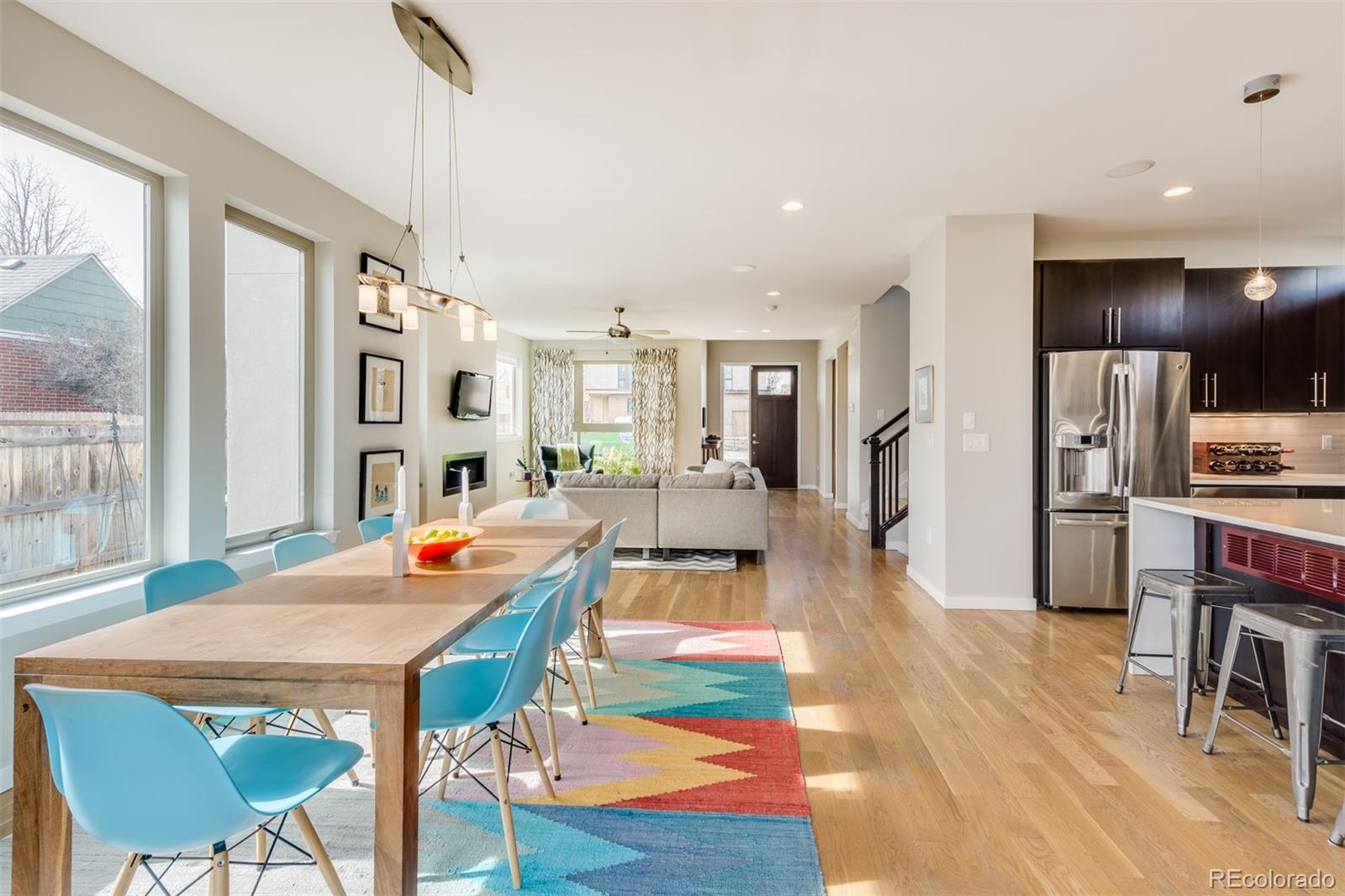 4030 Bryant Street Denver, CO 80211 - Photo 9 of 26 a dining room with furniture a kitchen view and a chandelier