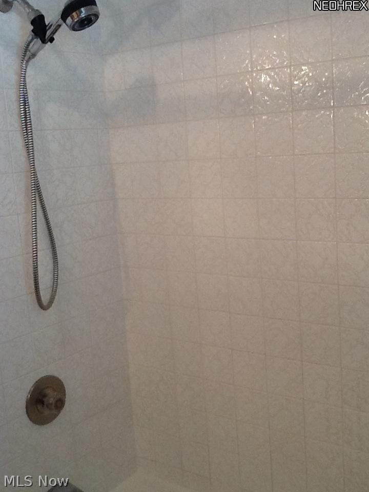 9850 West Pleasant Valley Road Parma, OH 44130 - Photo 7 of 15 Bathroom/shower white tile is in outstanding condition - clean and in move-in condition.