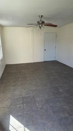 a view of a backyard with a tree