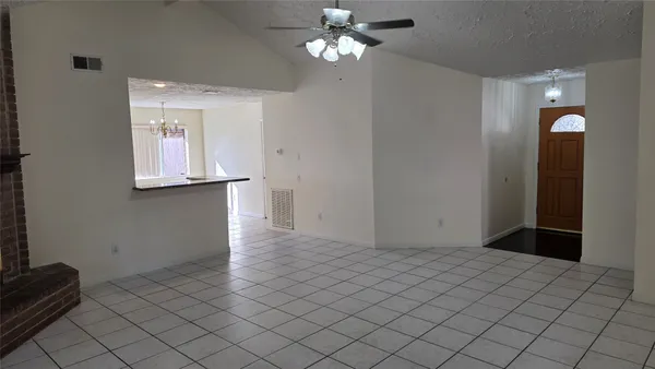 a view of a chandelier fan and entryway