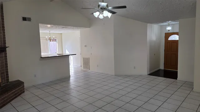 a view of a chandelier fan and entryway