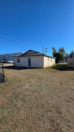 a view of a house with a yard and garage