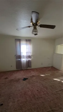 a view of an empty room and a window