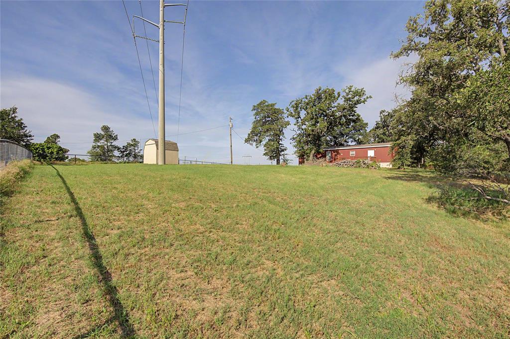 177 New Highland Road Springtown, TX 76082 - Photo 34 of 40 Expansive grassy lot with a detached shed and perimeter fencing