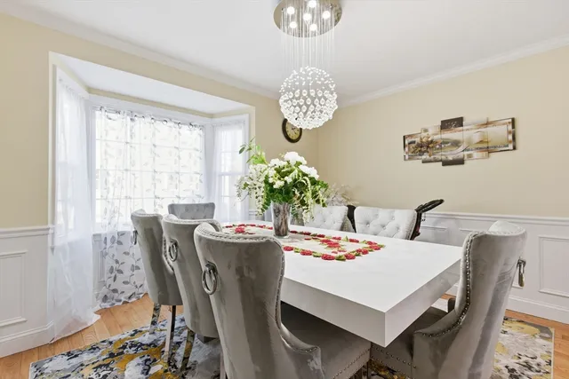a view of a dining room with furniture wooden floor and chandelier