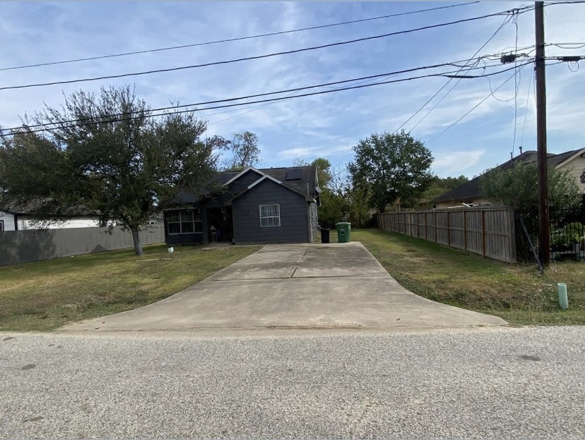 6114 Haight Street Houston, TX 77028 - Photo 5 of 11 a front view of a house with a yard and garage