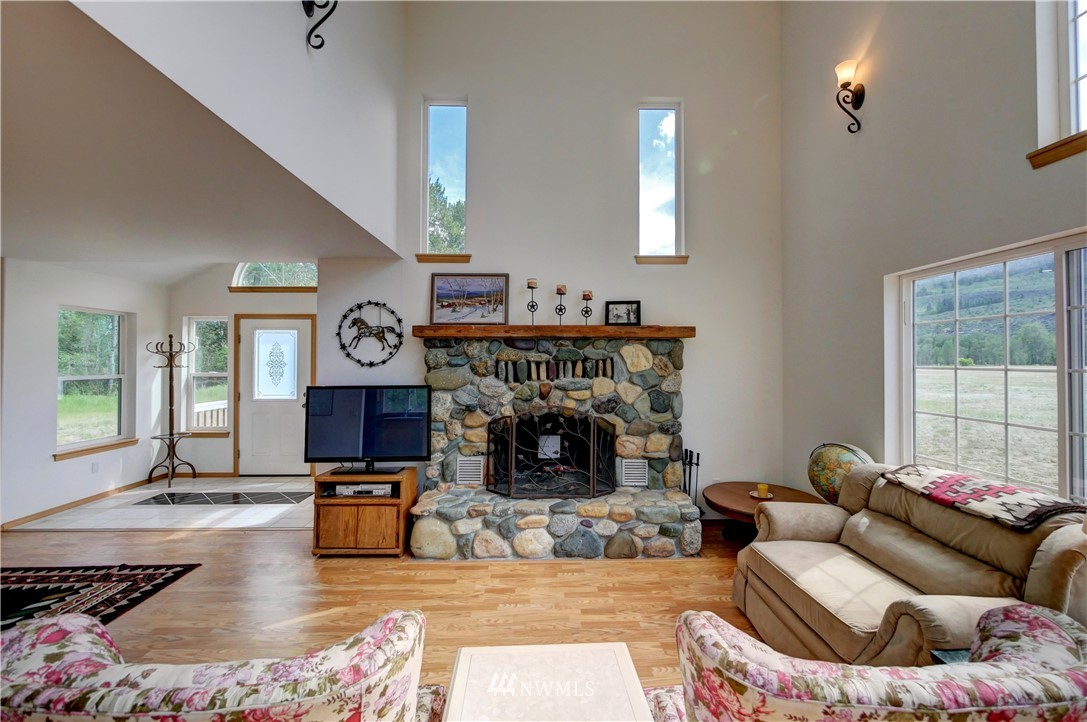36 Beaver Pond Road Twisp, WA 98856 - Photo 12 of 40 a living room with furniture large window and a fireplace