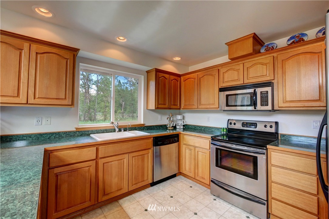 36 Beaver Pond Road Twisp, WA 98856 - Photo 22 of 40 a kitchen with stainless steel appliances granite countertop a sink stove and microwave