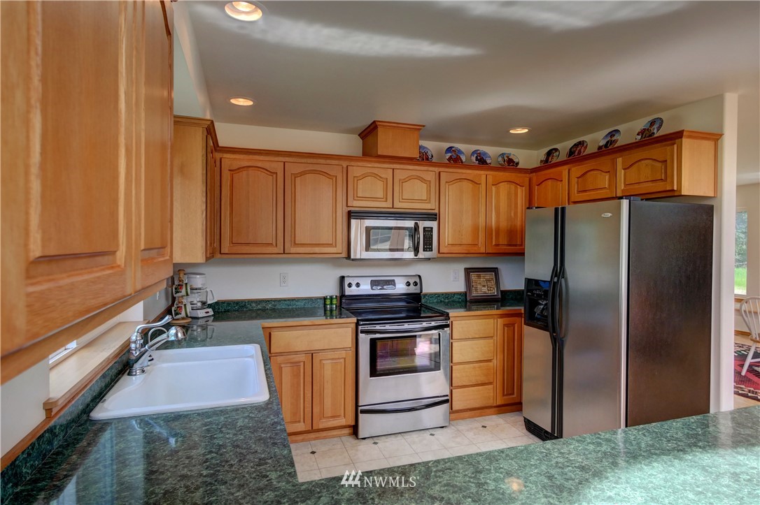 36 Beaver Pond Road Twisp, WA 98856 - Photo 23 of 40 a kitchen with stainless steel appliances granite countertop a refrigerator stove and sink