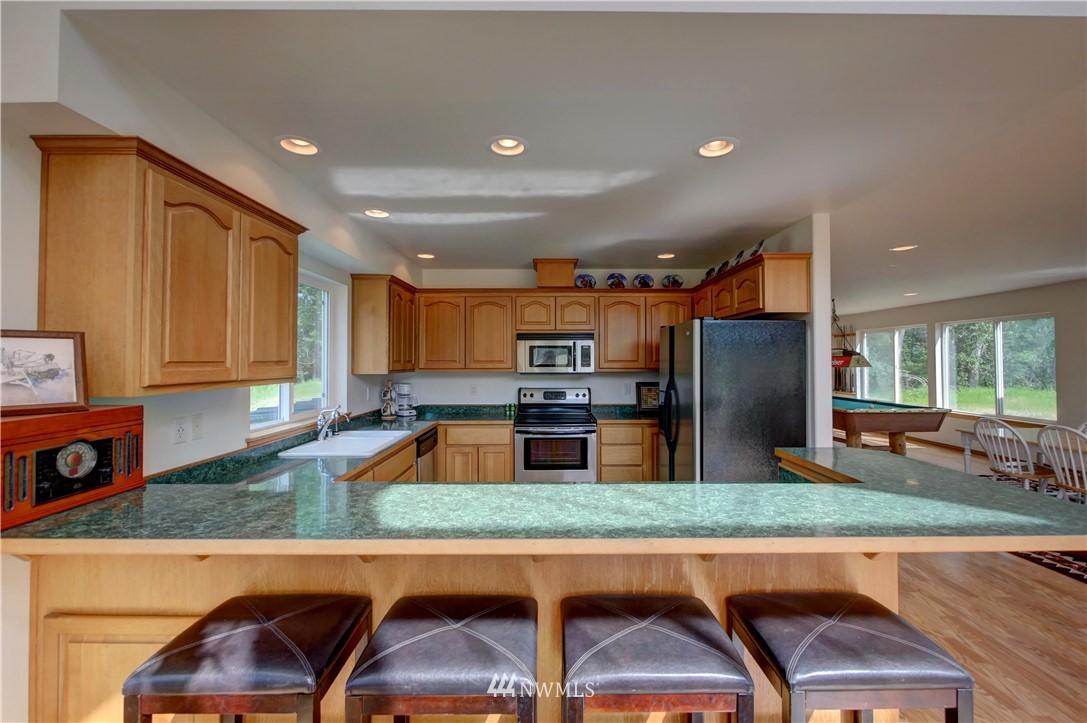 36 Beaver Pond Road Twisp, WA 98856 - Photo 24 of 40 a kitchen with stainless steel appliances granite countertop a refrigerator and a stove