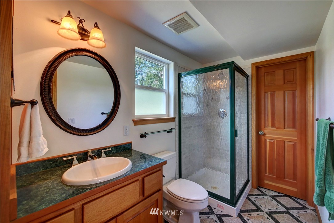 36 Beaver Pond Road Twisp, WA 98856 - Photo 27 of 40 a bathroom with a granite countertop toilet a sink and a mirror