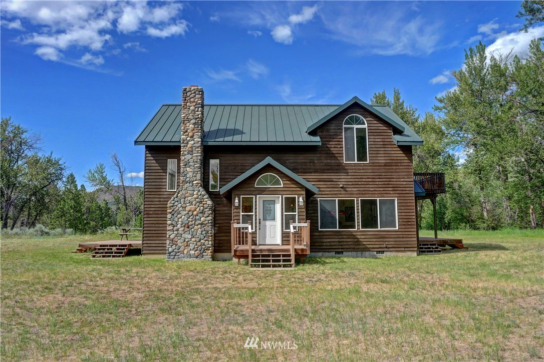 36 Beaver Pond Road Twisp, WA 98856 - Photo 4 of 40 a front view of a house with a garden
