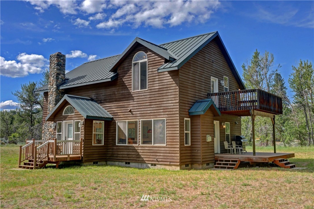 36 Beaver Pond Road Twisp, WA 98856 - Photo 38 of 40 a front view of a house with a yard