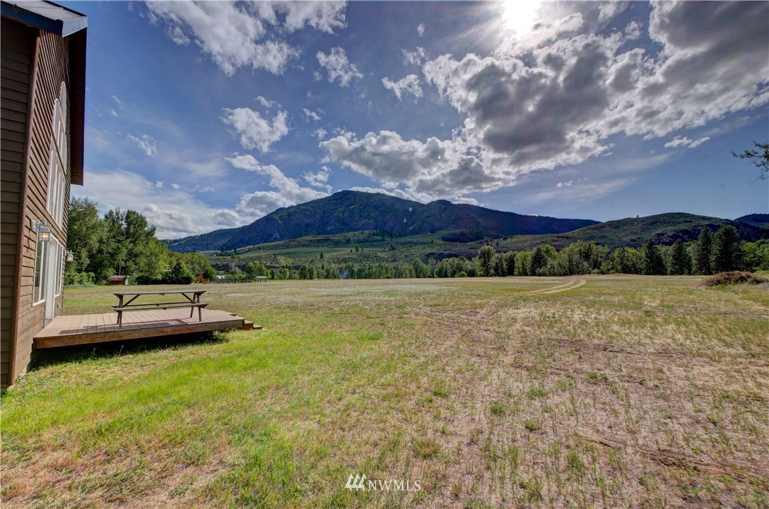 36 Beaver Pond Road Twisp, WA 98856 - Photo 39 of 40 a view of a house with a yard and a large tree