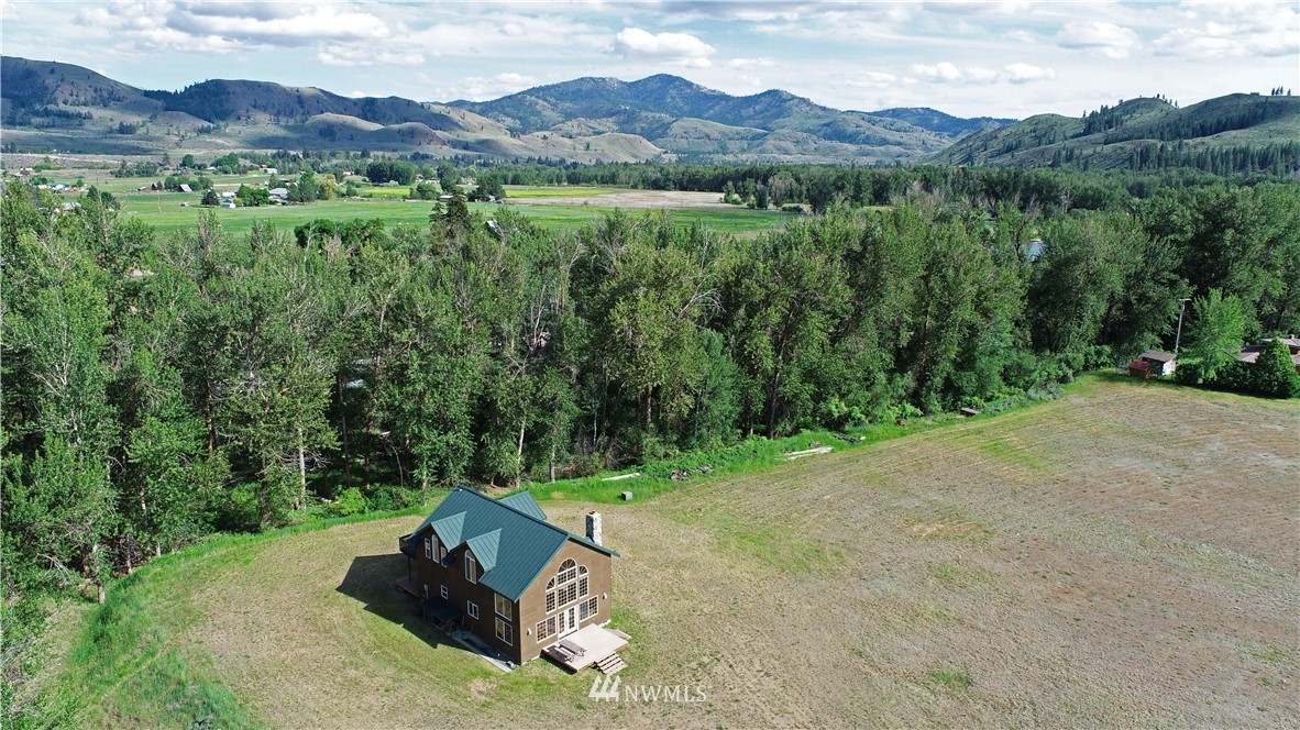 36 Beaver Pond Road Twisp, WA 98856 - Photo 5 of 40 a view of a lush green hillside and a houses