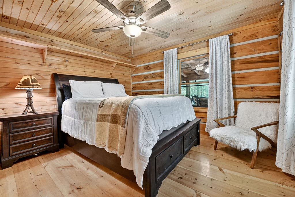 100 Stanley Creek Road Cherry Log, GA 30522 - Photo 14 of 81 a bedroom with a bed and a chandelier