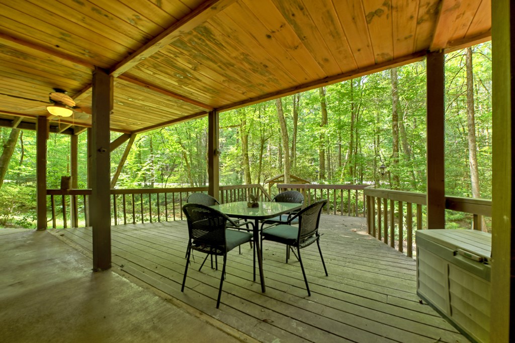 100 Stanley Creek Road Cherry Log, GA 30522 - Photo 27 of 81 a view of a patio with table and chairs and wooden floor
