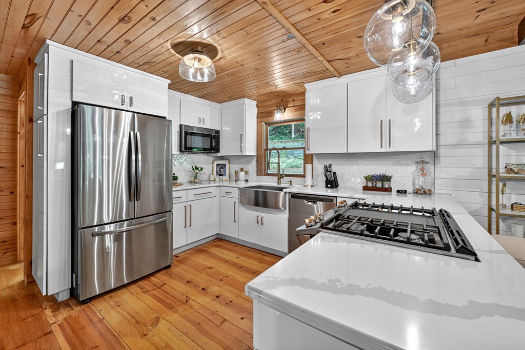 100 Stanley Creek Road Cherry Log, GA 30522 - Photo 4 of 81 a kitchen with stainless steel appliances a stove a sink a refrigerator cabinets and a dining table