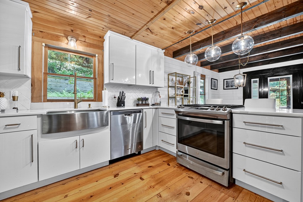 100 Stanley Creek Road Cherry Log, GA 30522 - Photo 44 of 81 a kitchen with a stove sink and cabinets