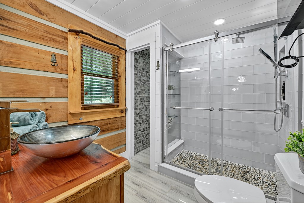 100 Stanley Creek Road Cherry Log, GA 30522 - Photo 51 of 81 a bathroom with a granite countertop bathtub sink vanity mirror and toilet