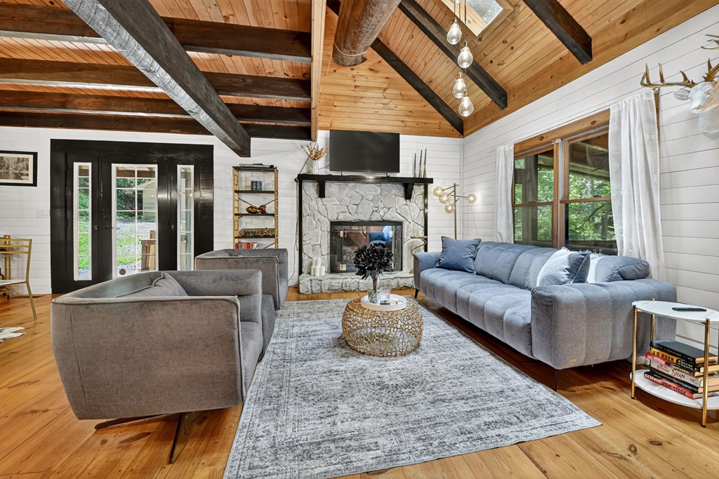 100 Stanley Creek Road Cherry Log, GA 30522 - Photo 9 of 81 a living room with furniture a flat screen tv and a fireplace