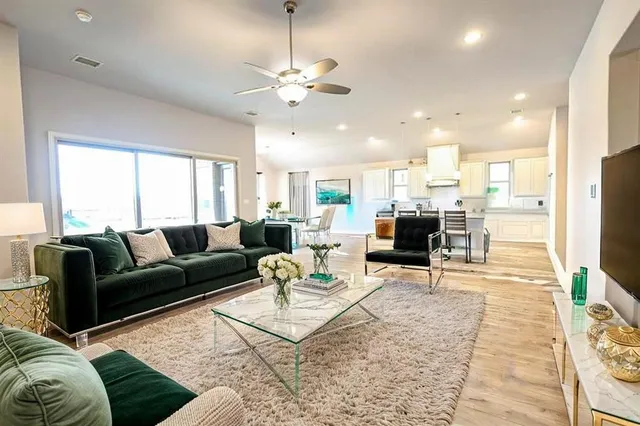 a living room with furniture a fireplace and a flat screen tv