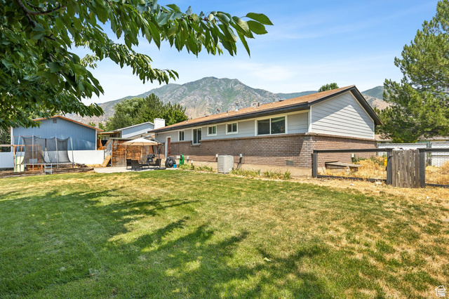 495 North 250 West Springville, UT 84663 - Photo 24 of 35 Back of house with brick siding, a gazebo, a mountain view, and a chimney