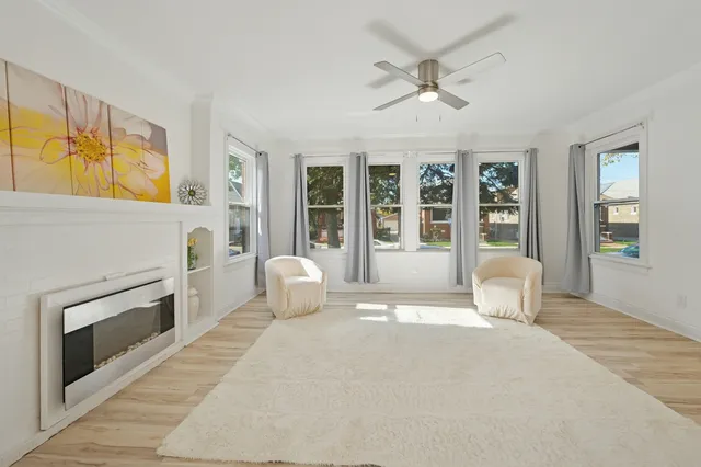 a spacious bedroom with a bed and wooden floor
