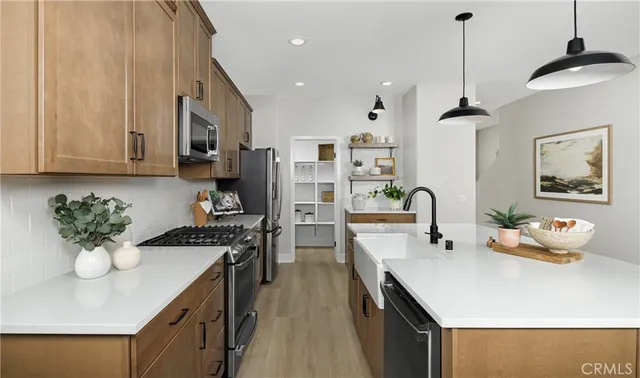 a kitchen with a sink appliances and cabinets