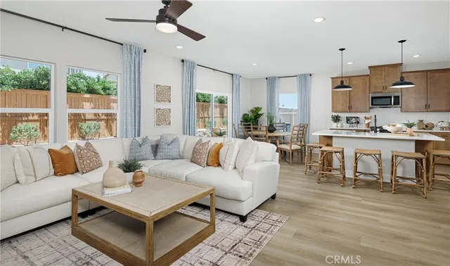 a living room with lots of furniture and a large window