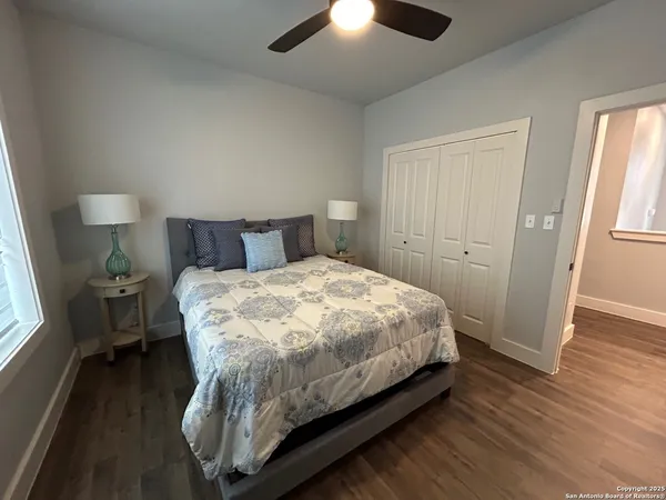 a bedroom with a bed and wooden floor