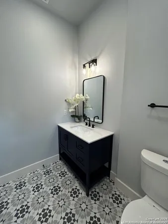 a bathroom with a toilet sink and mirror