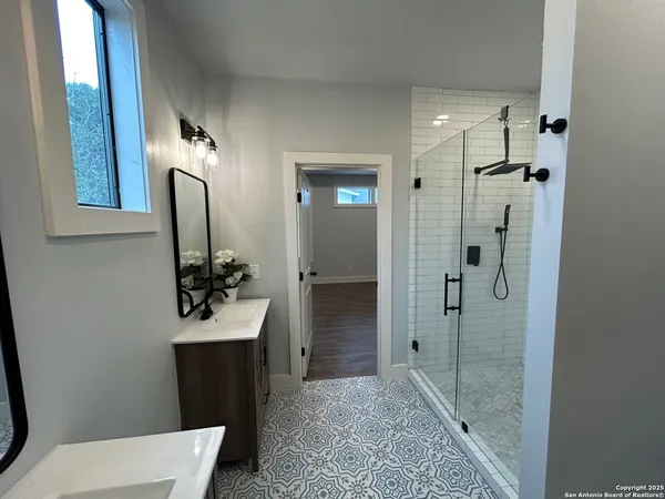 a bathroom with a sink and mirror