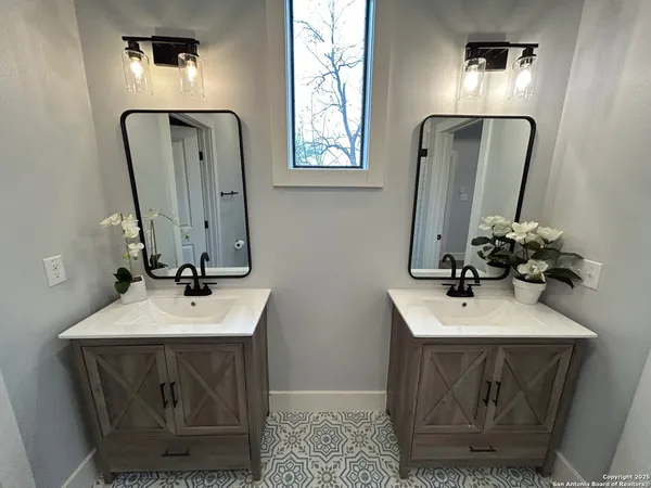 a bathroom with a sink a mirror and vanity