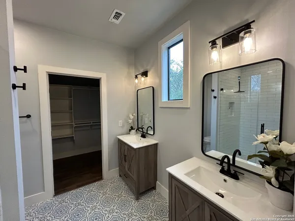 a bathroom with a sink double vanity and a mirror