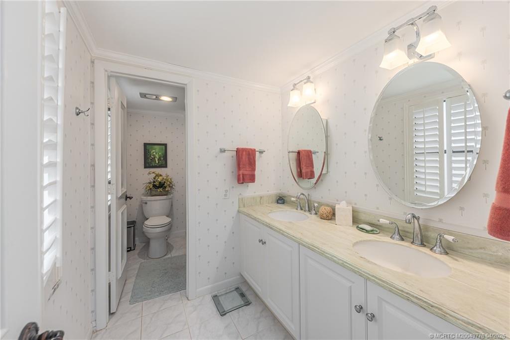 3901 Southeast St Lucie Boulevard, Unit 34 Stuart, FL 34997 - Photo 12 of 58 a spacious bathroom with a double vanity sink mirror and toilet