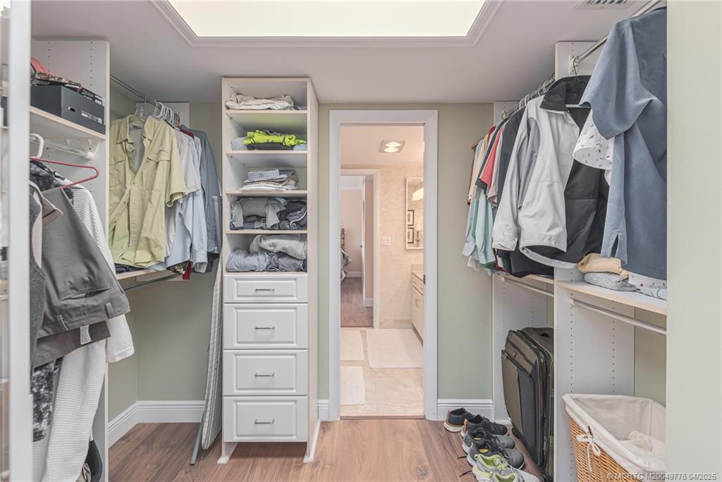 3901 Southeast St Lucie Boulevard, Unit 34 Stuart, FL 34997 - Photo 13 of 58 a view of walk in closet with clothes and shoes