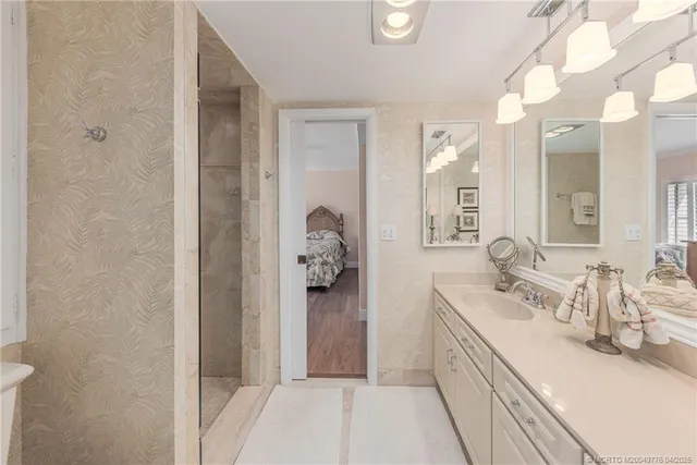 a bathroom with a double vanity sink toilet and shower