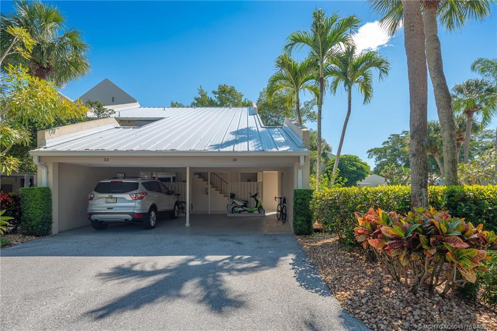 3901 Southeast St Lucie Boulevard, Unit 34 Stuart, FL 34997 - Photo 21 of 58 a view of a car park in front of house
