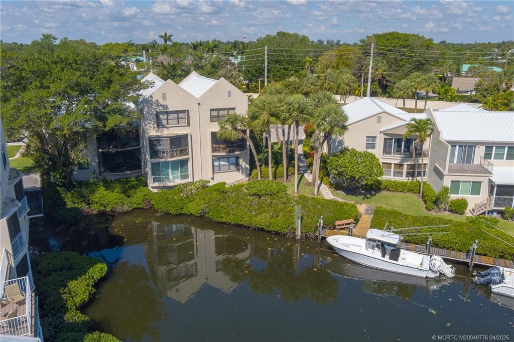 3901 Southeast St Lucie Boulevard, Unit 34 Stuart, FL 34997 - Photo 23 of 58 an aerial view of a house with a garden and lake view