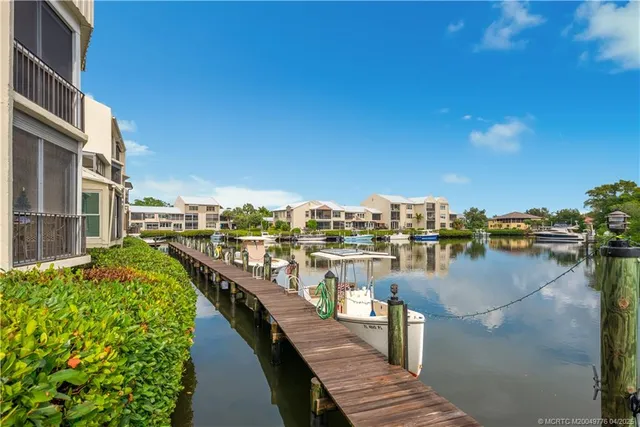 an aerial view of residential houses with outdoor space and river