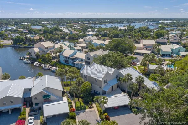 an aerial view of a house with outdoor space and lake view