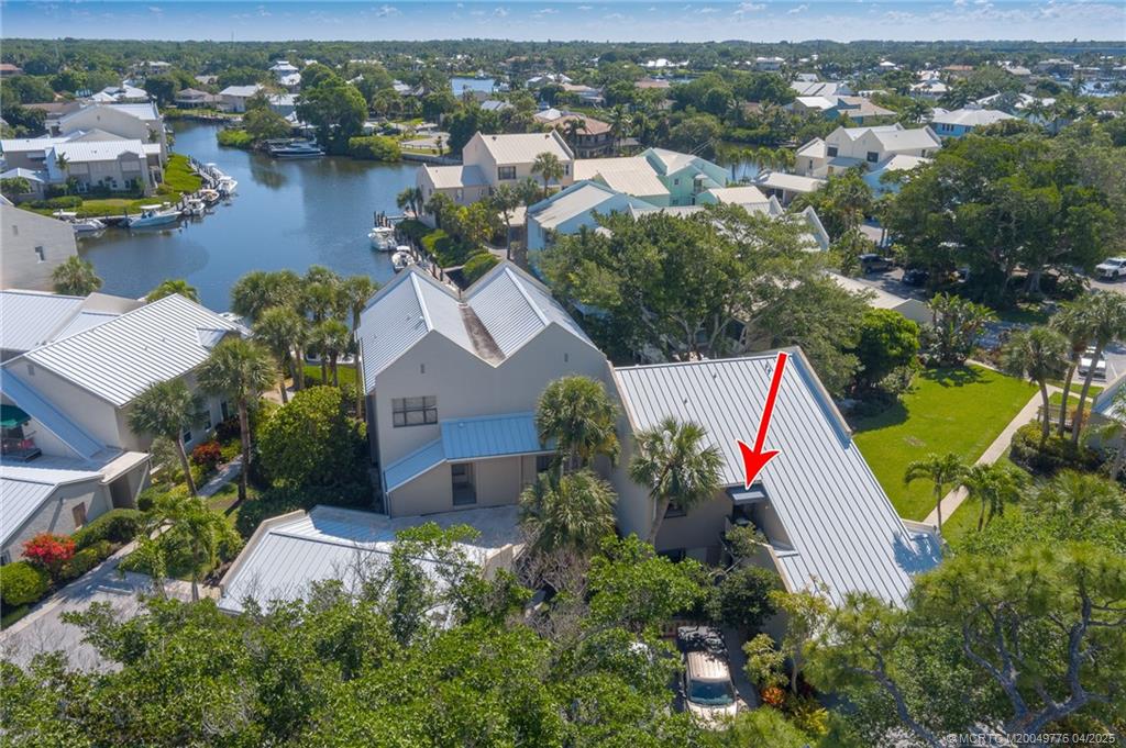 3901 Southeast St Lucie Boulevard, Unit 34 Stuart, FL 34997 - Photo 32 of 58 an aerial view of residential house with outdoor space and lake view