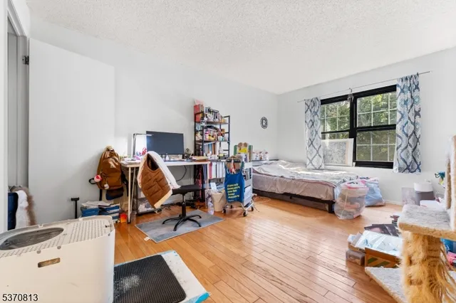 a bedroom with furniture and a wooden floor