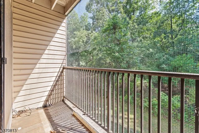 a view of a balcony with wooden floor