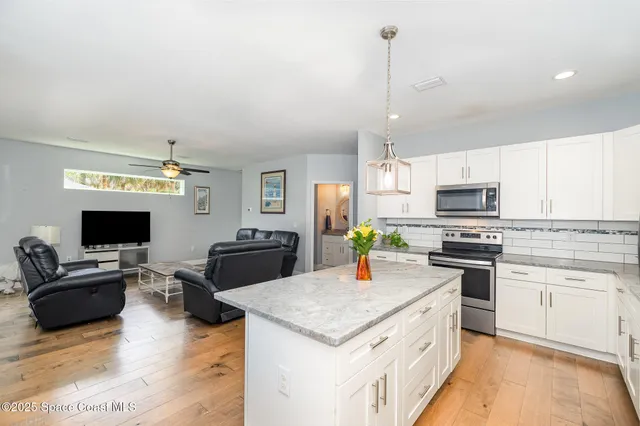 a kitchen with a stove a sink and a refrigerator
